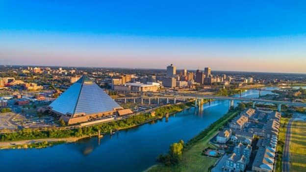 Aerial view of Memphis at sunset: the Pyramid, downtown skyline, and riverfront